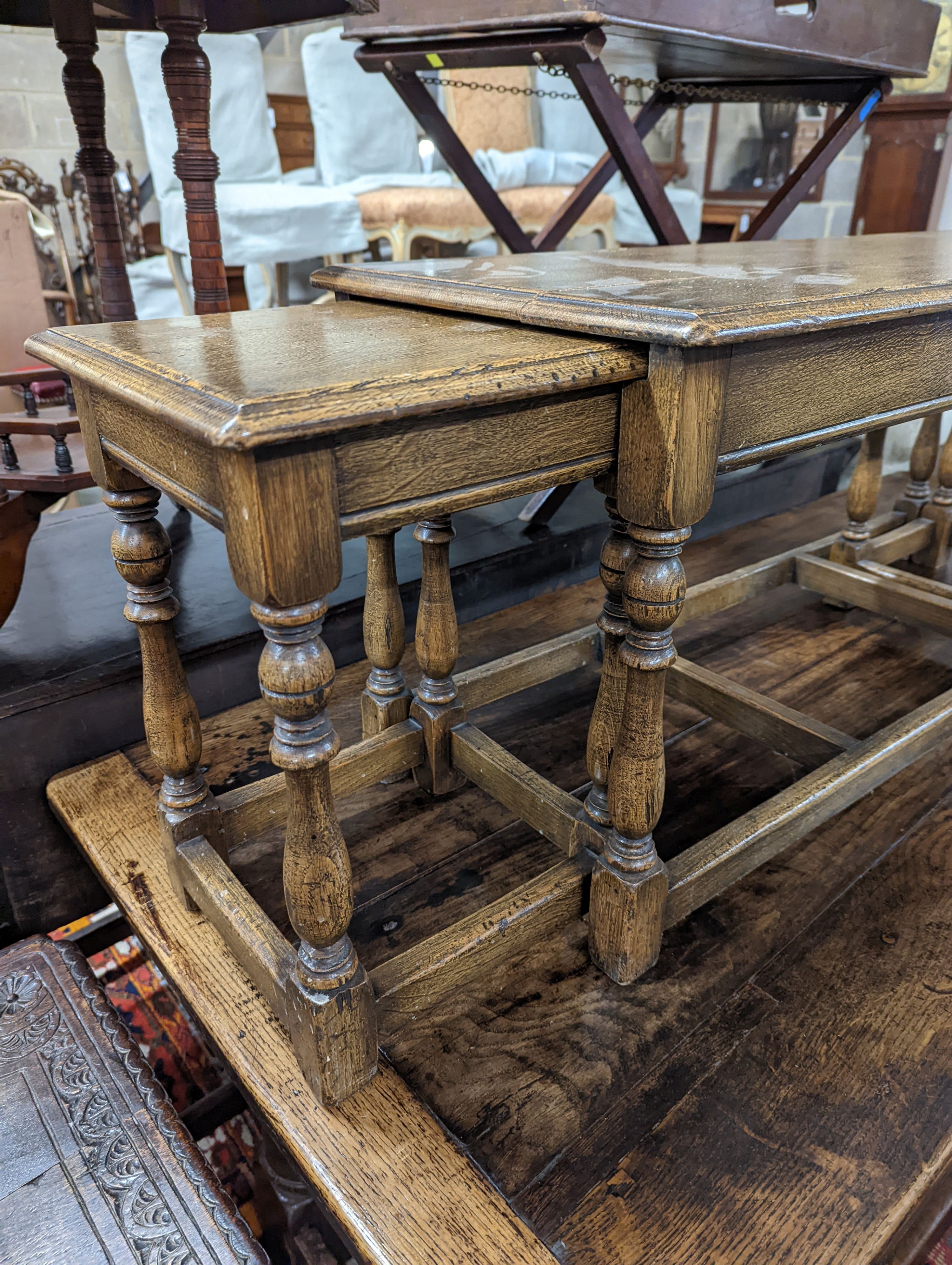 A nest of 18th century oak occasional tables, width 101cm, depth 38cm, height 46cm